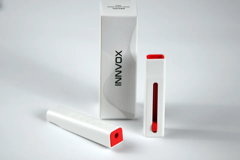 INNVOX whistle, cap, and retail box in a bright studio scene.