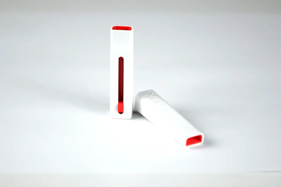 INNVOX vocal training whistle arranged on a bright studio surface.